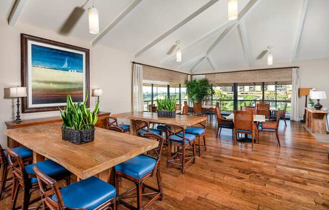 a large dining room with tables and chairs and a large window