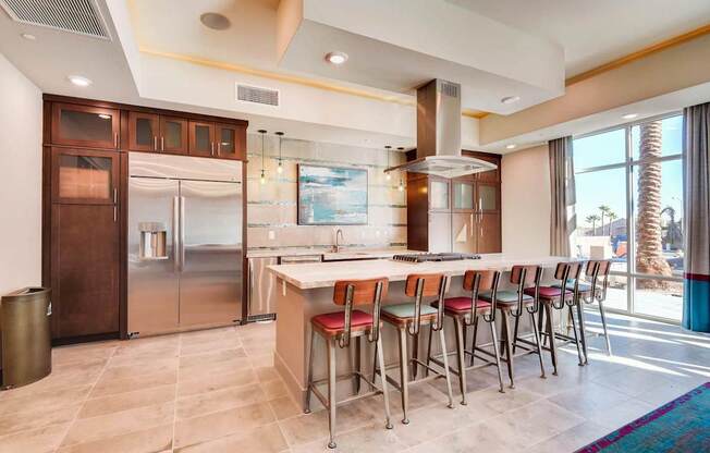 A modern kitchen with a long table and chairs.