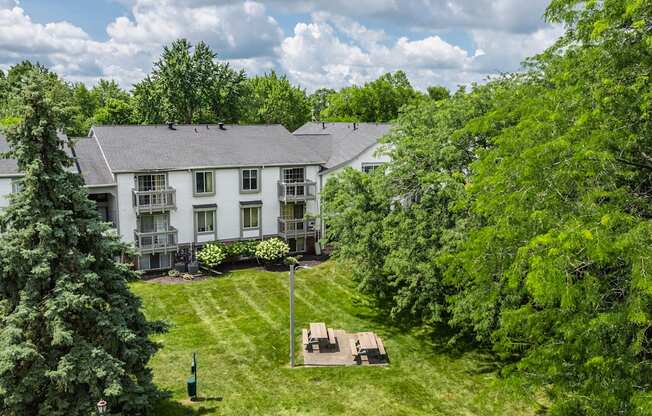 A white building with a green lawn in front