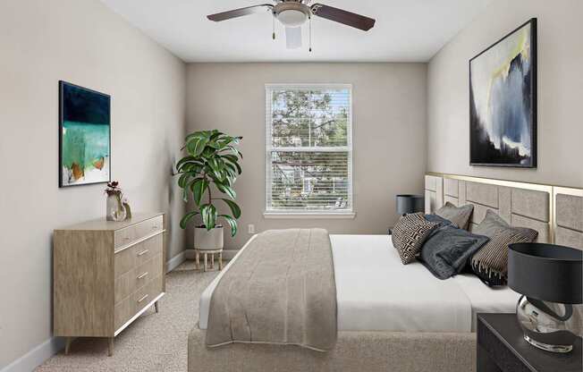 A bedroom with a bed, nightstand, and a painting on the wall.