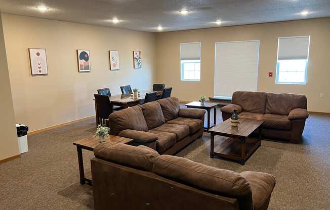 a living room with couches and tables at Bluemont Village Apartments, Fargo