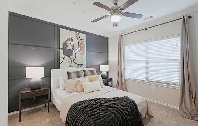 a bedroom with a bed and a ceiling fan