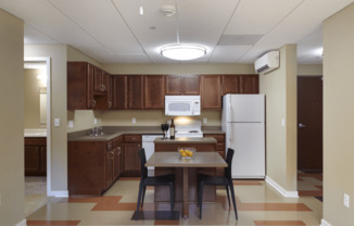 a kitchen with wooden cabinets and a white refrigerator