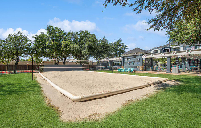 Outdoor Sand Volleyball Court with Net at Allure North Dallas Apartments in Dallas, TX.