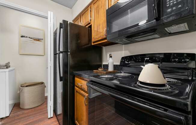 a kitchen with a stove top oven next to a refrigerator