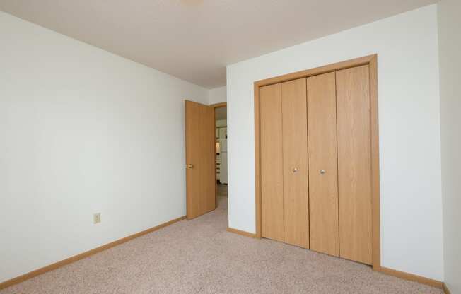 Fargo, ND Twin Parks Apartments. a bedroom with two closets and a carpeted floor
