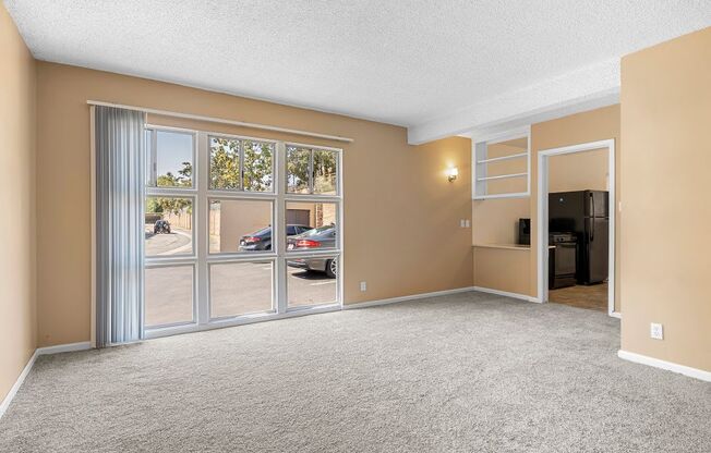 an empty living room with a large window