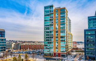 an aerial view of an office building with a city in the background