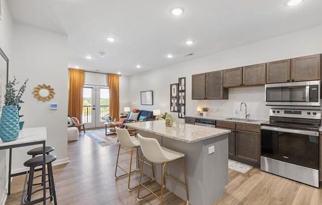 A modern kitchen with a bar area and a dining table.