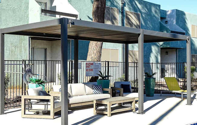 A poolside lounge area with a canopy and seating.