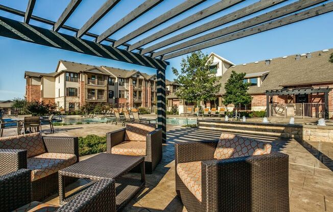 an outdoor patio with tables and chairs under awning  at Platinum Castle Hills, Lewisville, TX, 75056