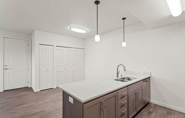 A kitchen with a sink and cabinets.