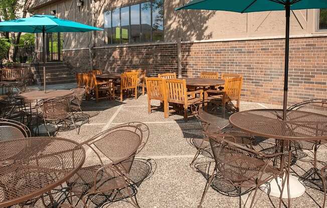 Outdoor community patio with umbrella tables and outdoor dining tables.