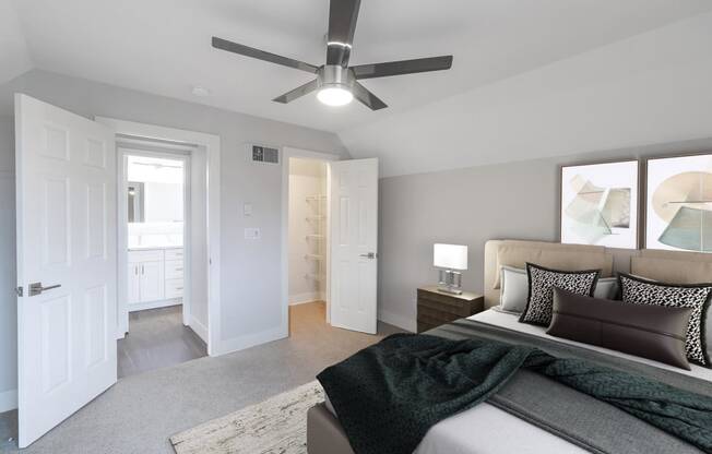 a bedroom with a bed and a ceiling fan