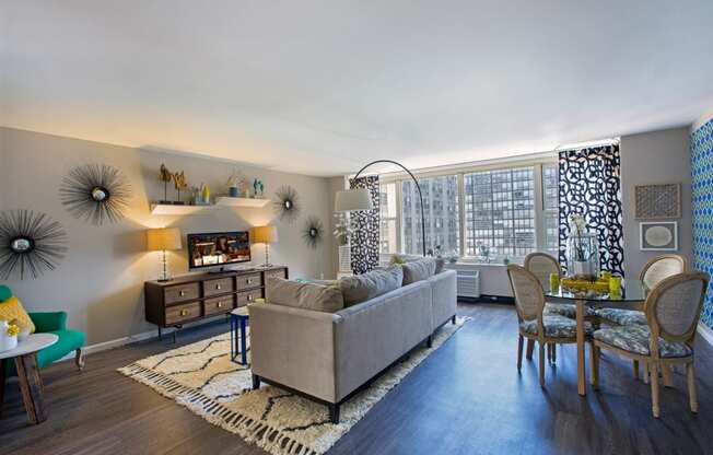 a living room with a couch and a table and a large window