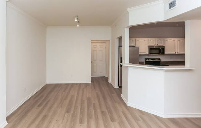 A kitchen area with a countertop and cabinets.