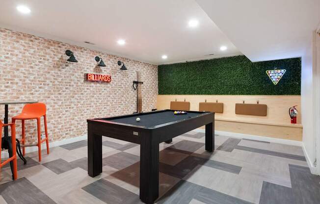 a game room with a pool table and a bar