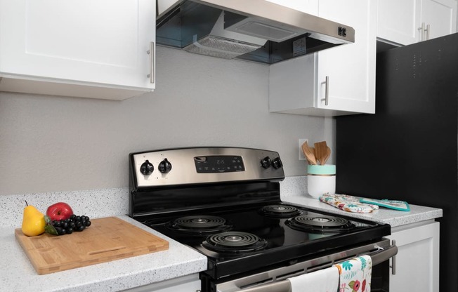 Bayview Apartment Homes Black Stovetop and Cabinets