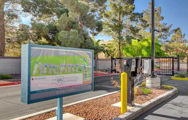 A sign for a community named Ambercreek stands in front of a gated entrance.