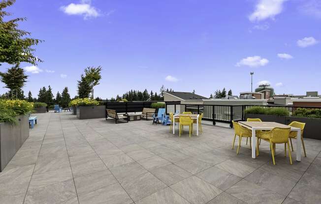 a resident rooftop terrace with tables and chairs at Arabella Apartment Homes, Shoreline, Washington 98155