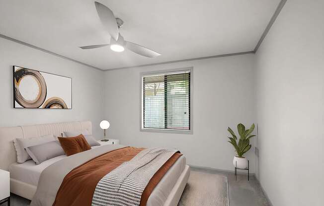 Retreat at Indian Lake Hendersonville TN apartments bedroom with a bed, a ceiling fan, and a plant.