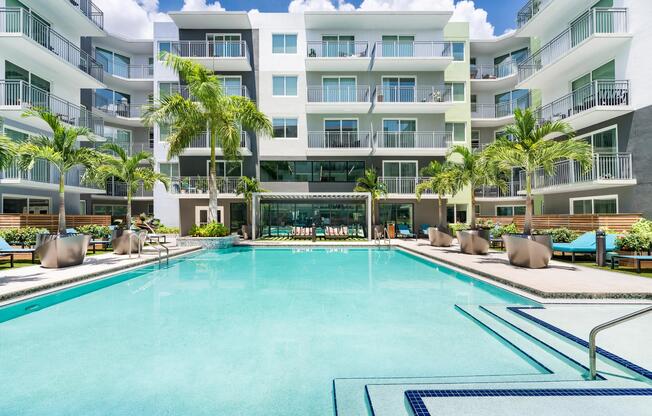 The resort-style pool features expansive swimming areas, lap lanes, poolside lounging, and a landscaped courtyard designed for relaxation and recreation.