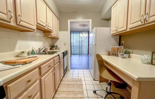 A kitchen with wood cabinets and a white refrigerator.