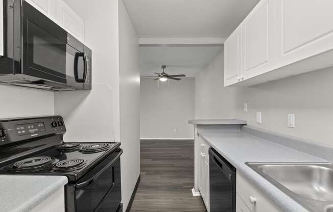 Kitchen with white cabinets and a black stove top oven at Creve Coeur, Creve Coeur, MO