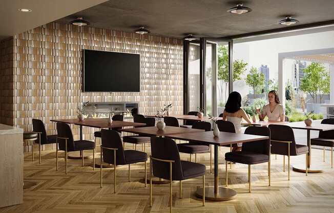A conference room with a long table and chairs, a television on the wall, and a view of the city outside the windows.