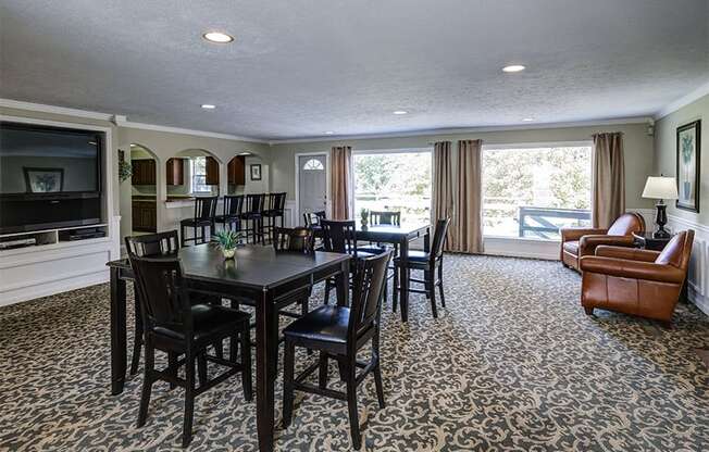 Clubhouse with seating and entertainment center at Ashton Pointe Apartments