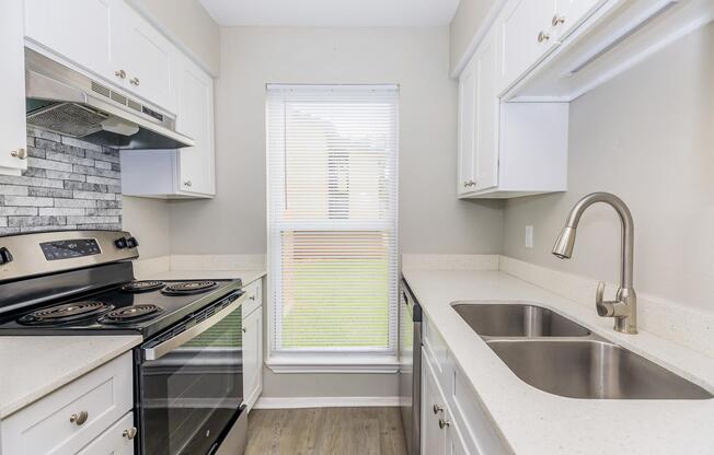 a stove top oven sitting inside of a kitchen