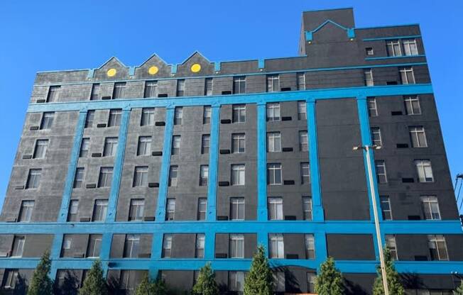 a tall building with a blue facade and a blue sky
