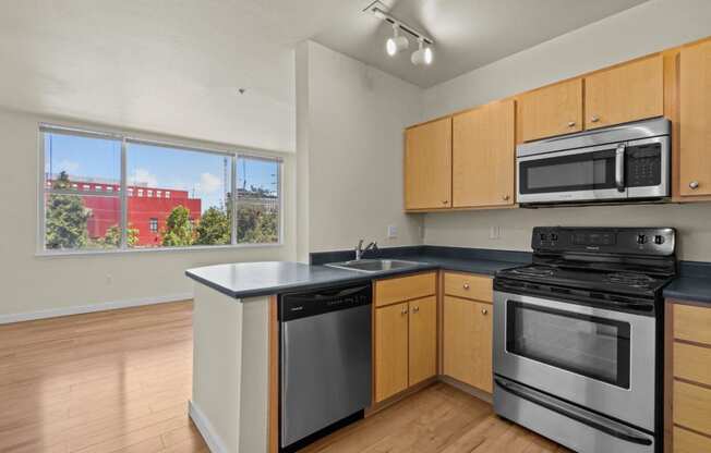 a kitchen with stainless steel appliances and wooden cabinets