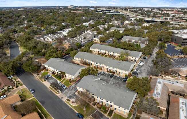 A road runs through a residential area with houses on either side.