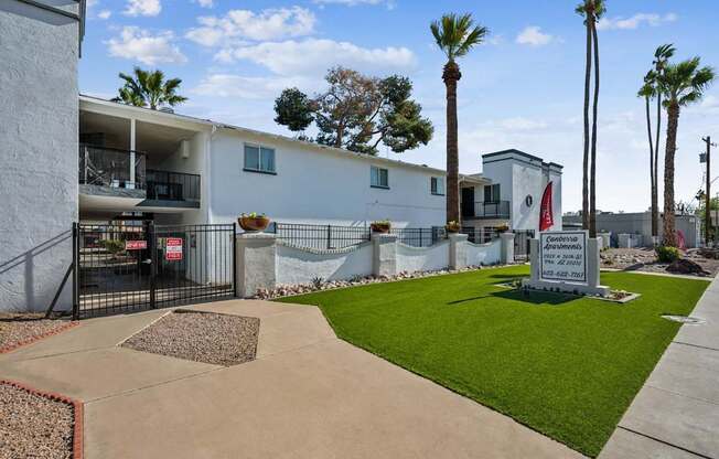 A white building with a black gate and a sign that says "Congress".