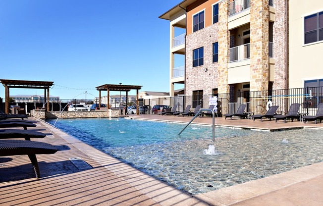 a swimming pool with a building in the background