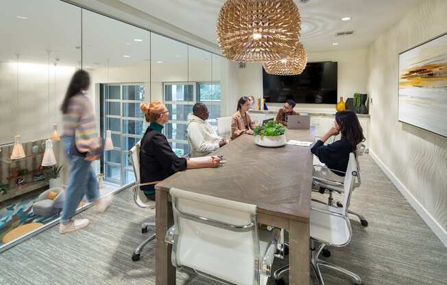 a group of people sitting around a table in an office