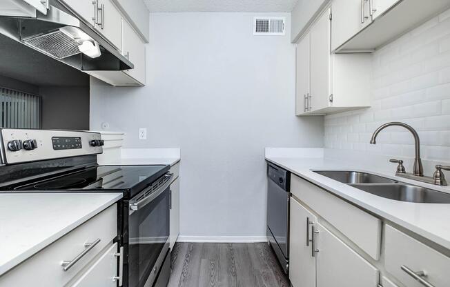 a kitchen with a stove and a sink