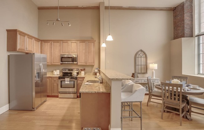 a kitchen and dining room with a table and chairs