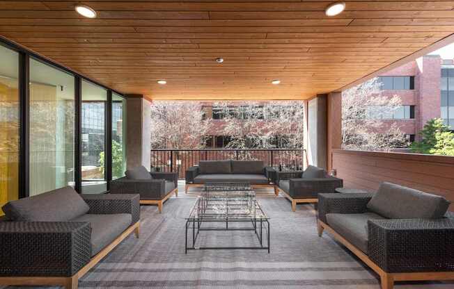 A patio with a table and chairs with a view of a building.