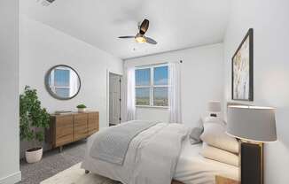 A bedroom with a bed, a ceiling fan, and a window with blinds at Andover Pointe Apartment Homes, La Vista, NE, 68138