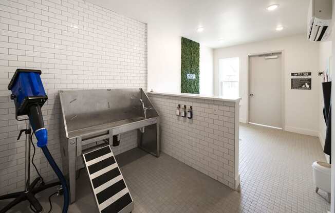 a large stainless steel sink in a room with a dryer