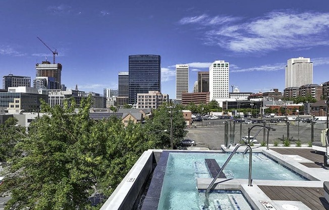 A rooftop pool with a city skyline in the background.
