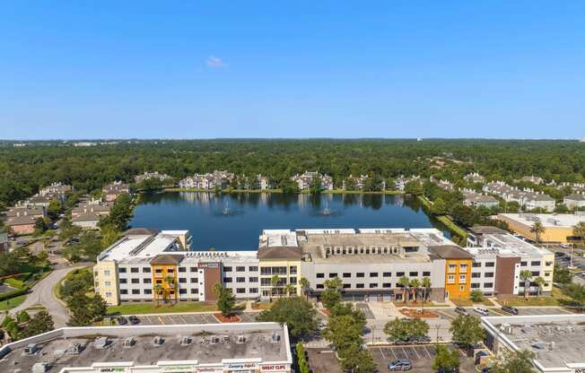 an aerial view of a building next to a lake