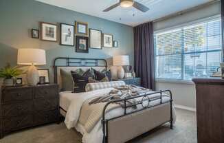 a bedroom with a bed and a ceiling fan