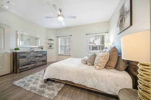 a bedroom with a large bed and a ceiling fan