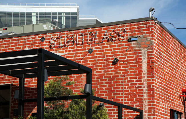 A red brick building with a black awning and the words