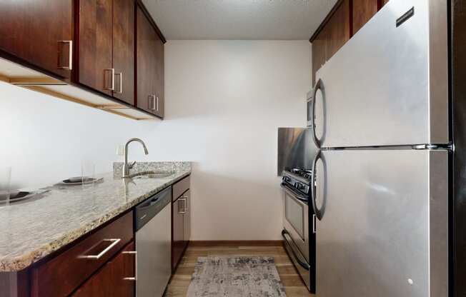 a kitchen with stainless steel appliances and a granite counter top