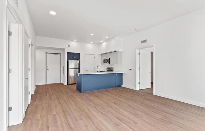 a kitchen with a blue counter top in a large room