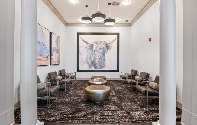 a lobby with couches and chairs and a picture of a bull at Mission Gate, Texas